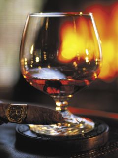 Сигара и виски на фоне камина