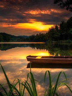 Лодка, лесное озеро и закат