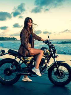 Девушка на мотоцикле у моря